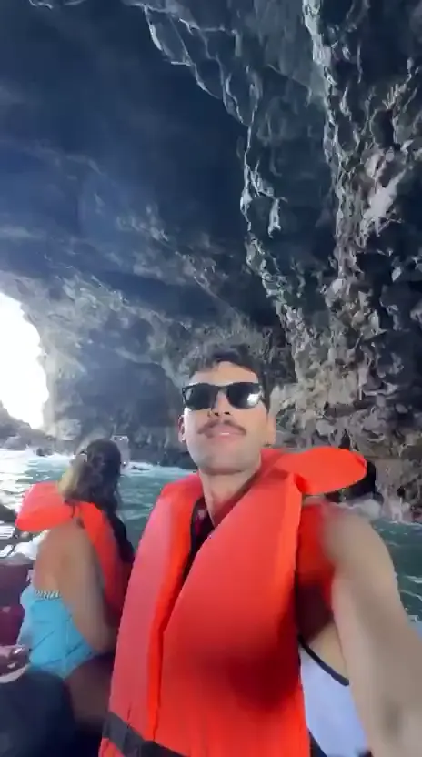 Visitors wearing life jackets inside the Águas Belas sea caves