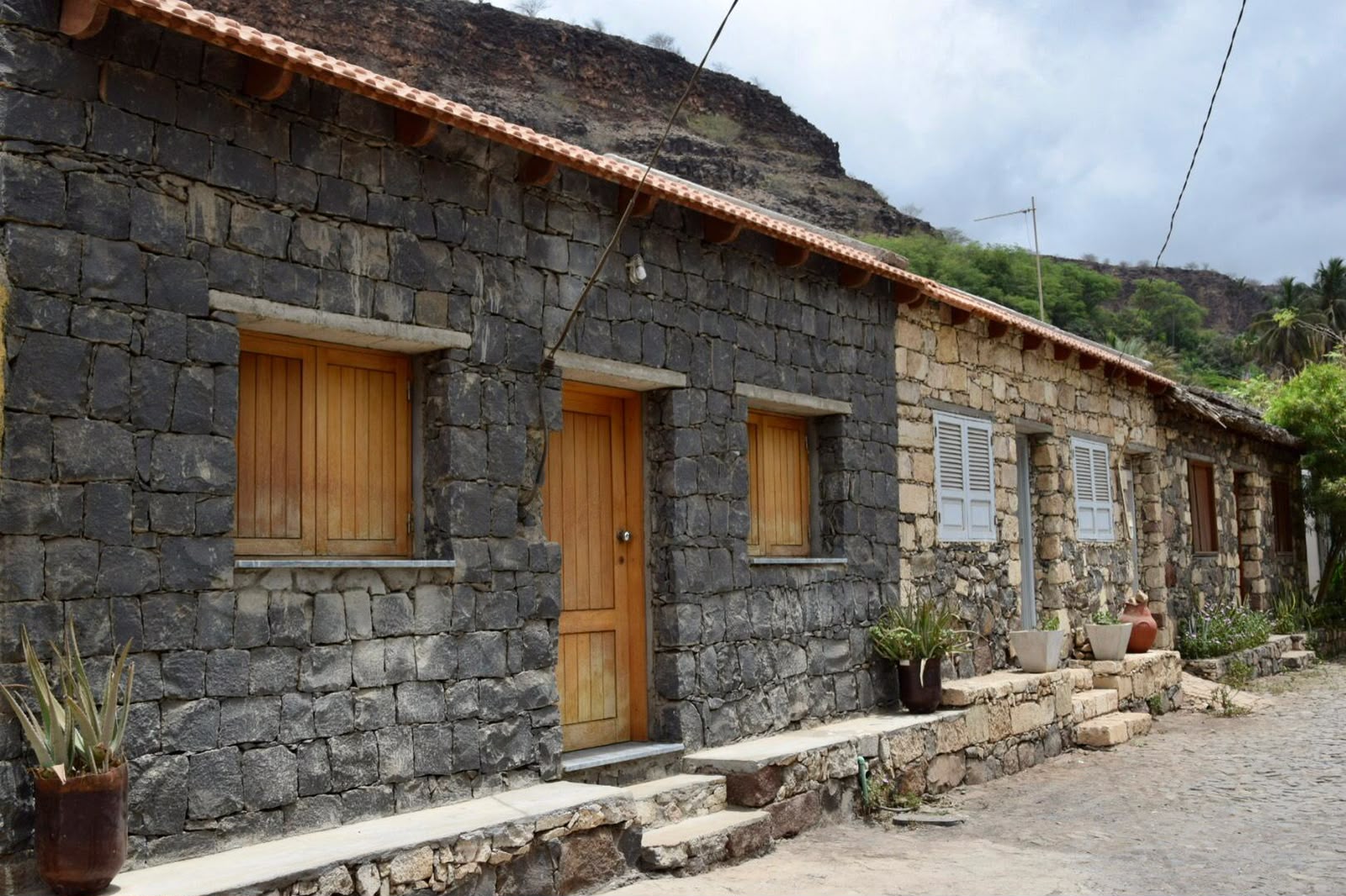 Traditional volcanic stone houses with wooden doors in Cidade Velha, Santiago