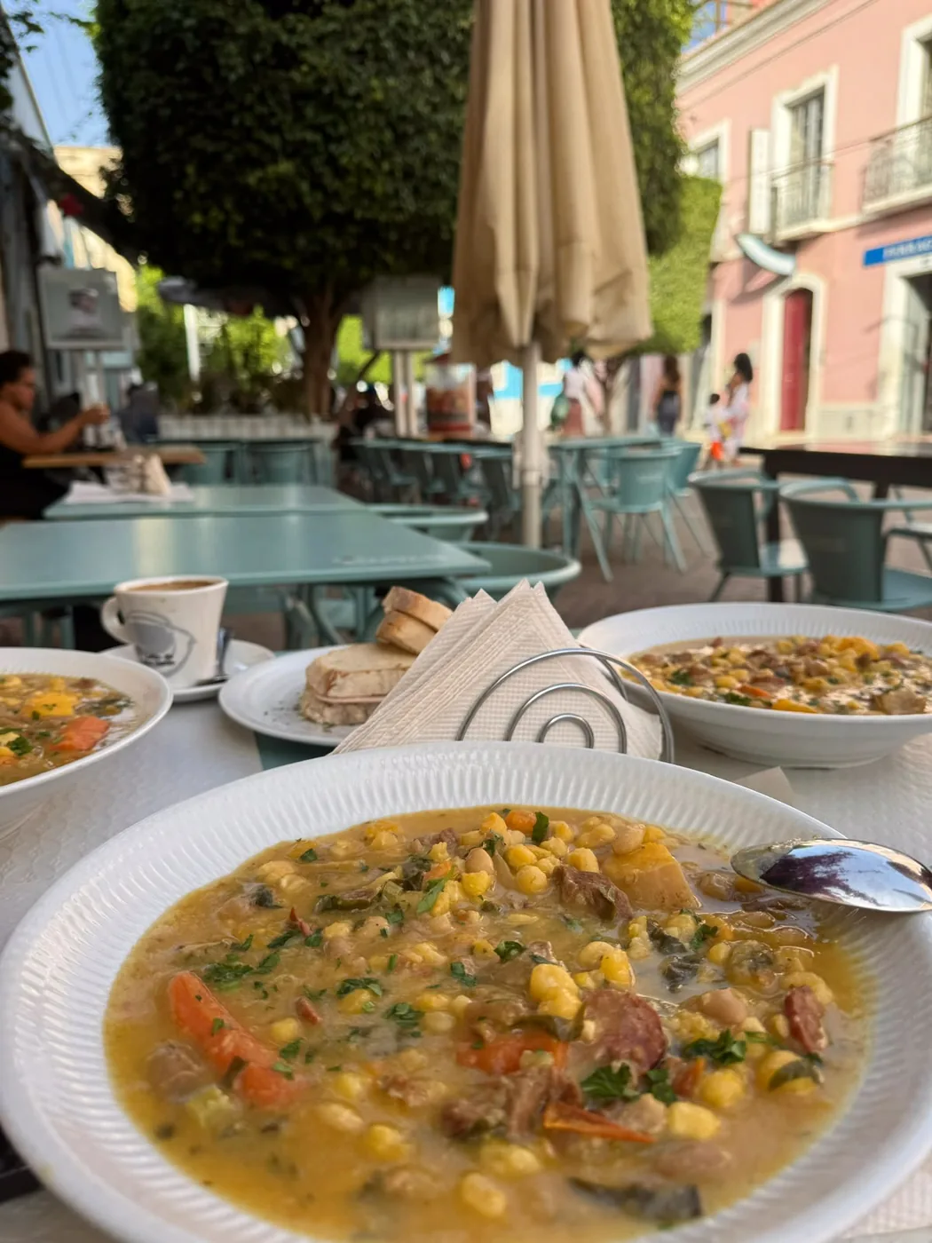 Bowls of corn and bean stew served at an outdoor café
